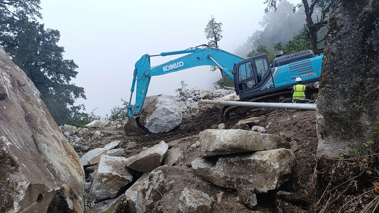 Excavator and site worker during quarry development at Kailash Granite Quarry in Kailash Rural Municipality, Makwanpur, Nepal.