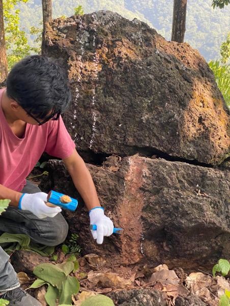 Close inspection of iron-bearing rock at the Bagmati prospecting site