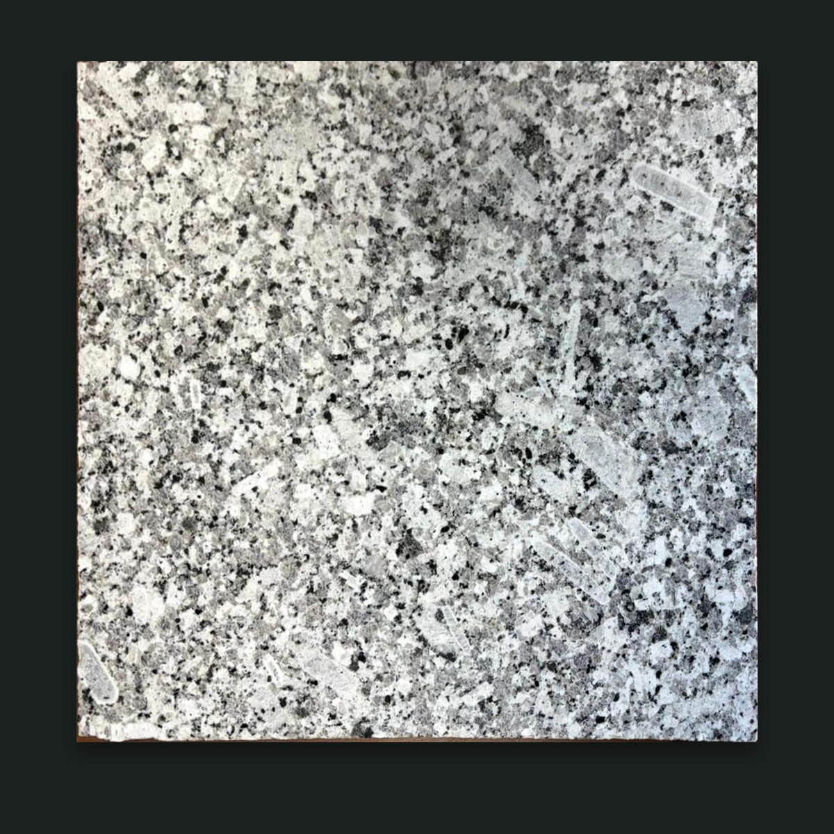 Cut Palung Steel Grey granite sample on graphite background